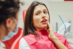 a woman talking to her dentist about a toothache