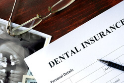 a dental insurance form on a wooden table
