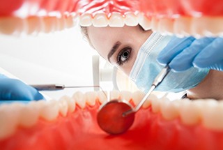 A dentist examining a patient’s gum tissue