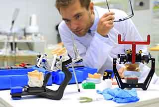 a lab technician crafting a denture