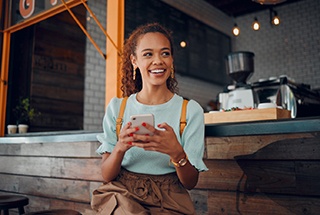 Smiling woman sitting on barstool at restaurant