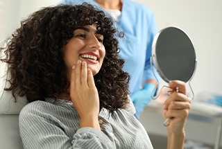 Woman smiling at reflection in mirror