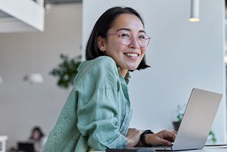 Woman with glasses smiling in office