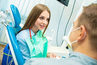 A female patient listens carefully as her dentist explains the use of oral conscious sedation