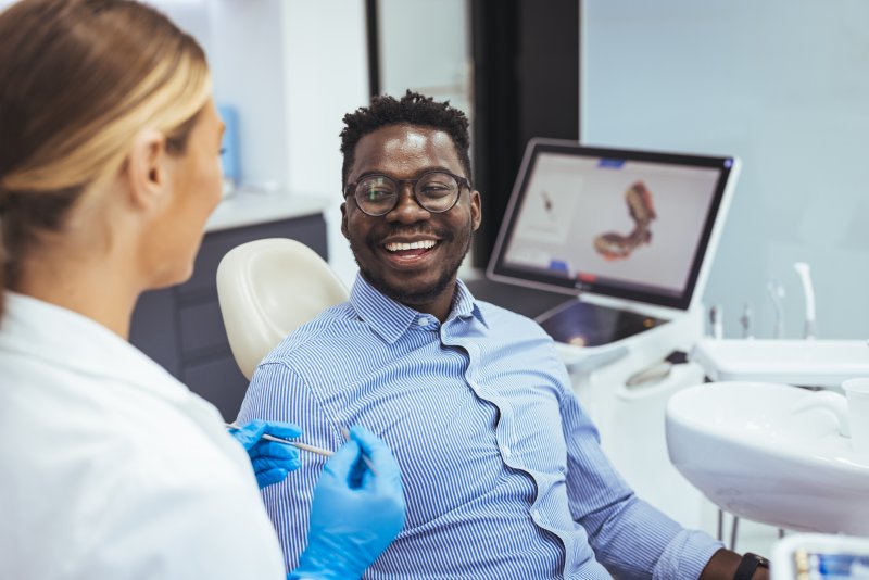 Patient smiling with their dental bridges